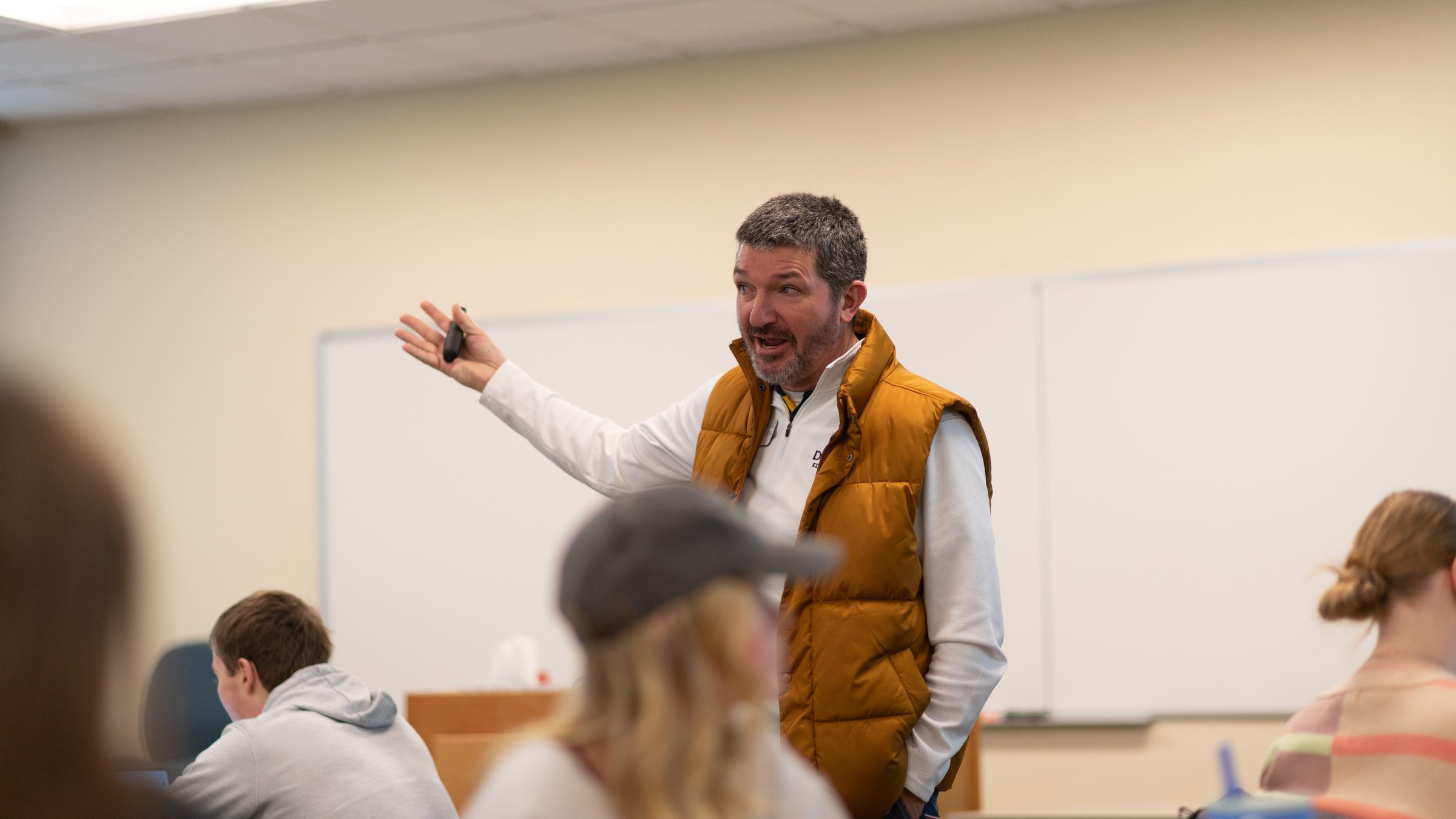 Matt Beimers gesturing as he explains something to a class