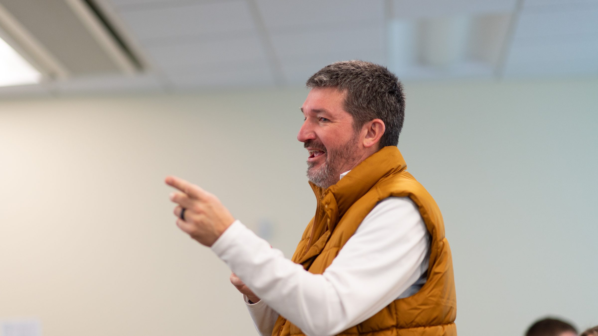 Matt Beimers mid-gesture as he teaches a class, smiling